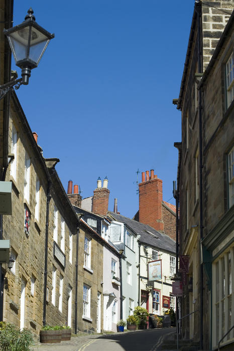 Narrow Kings Street in the fishing village of Robin Hoods Bay in Yorkshire line with traditional terraced stone houses