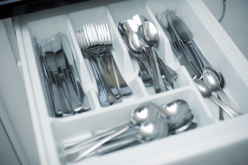 a nerrow depth of field image of the inside of a kitchen cutlery drawer