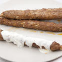 8461   Grilled kofta kebabs drizzled in yoghurt