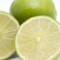 8423   Close up of two fresh nutritious limes, on white