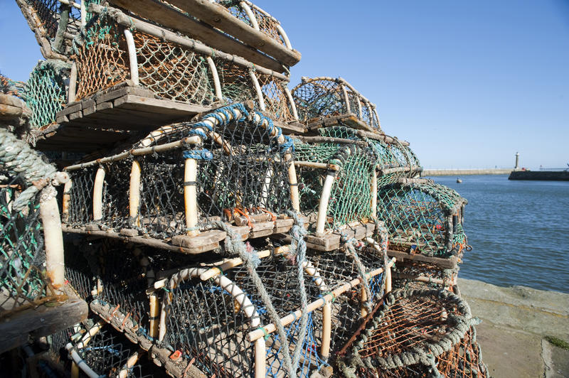 Stack of rusty wire mesh crab or lobster pots used by fishermen on the quay at Whitby harbour