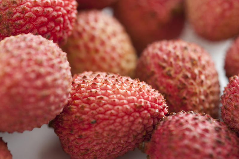 Close up Plenty of Healthy Fresh Sweet Pink Lychee Fruits on a White Table