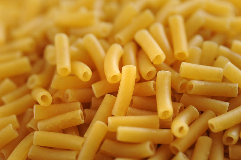 Close-up of pile of uncooked macaroni pasta tubes