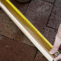 10170   Man measuring a length of wood