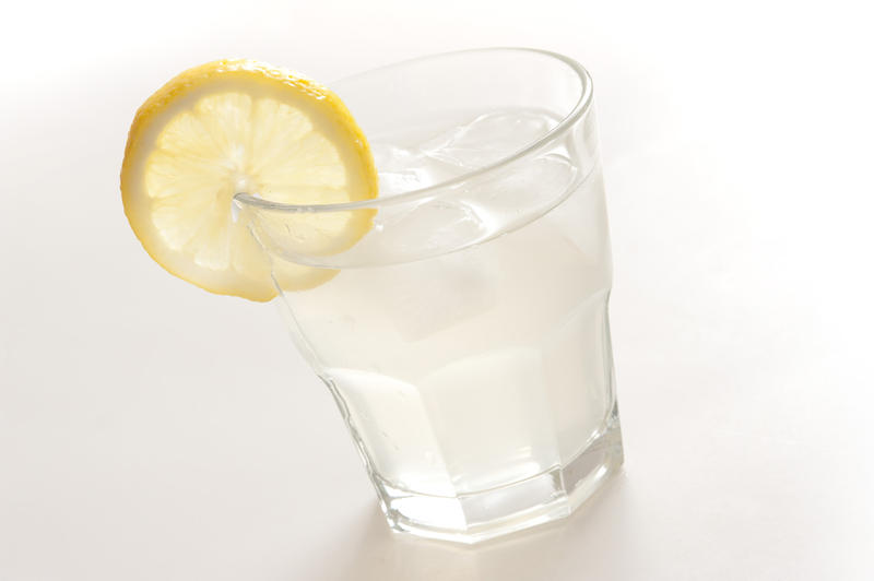 Mixer drink with white spirits mixed with soda, lemonade or tonic and garnished with a slice of fresh lemon