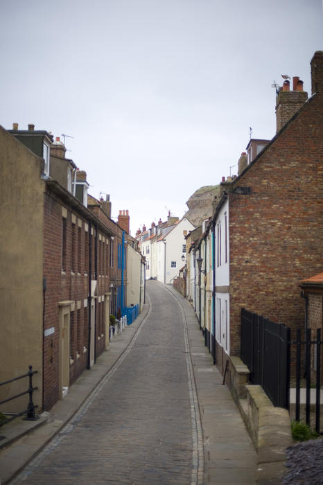 Quaint cottages lining the narrow deserted road of Henrietta Street on the East Cliff in Whitby