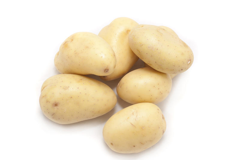 Pile of young cleaned fresh new potatoes for vegetarian and vegan cuisine or for use in salads and cooking as a vegetable rich in carbohydrate and nutrients
