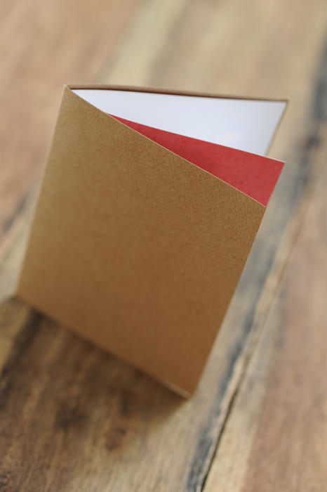 A blank card on a wooden table ready to add your own message