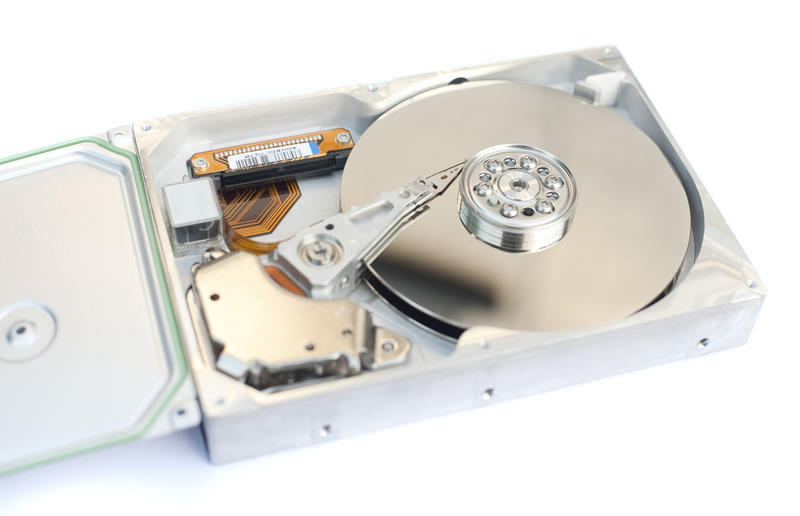 Close up Internal Parts of a Typical Computer Open Hard Disk Isolated on White Background.