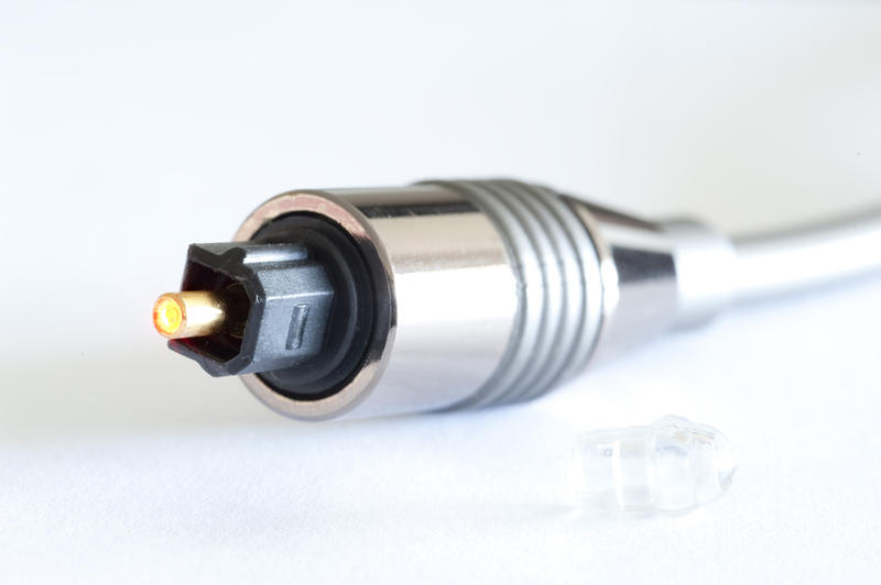 Close up Glowing Fiber Optical Connector for Computer Networking Isolated on a White Background