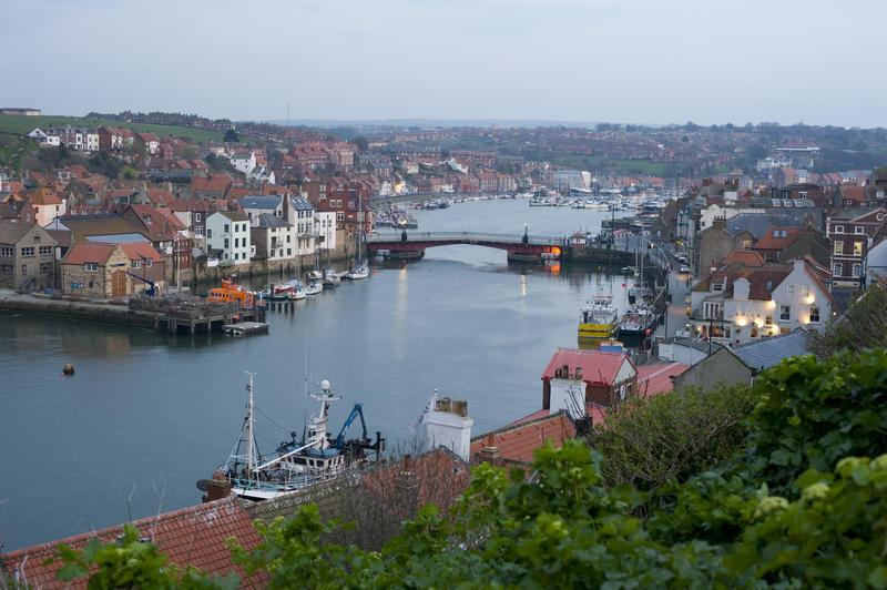 Picturesque view from the hill of the swing bridge in Whitby harbour and the buildings of the town