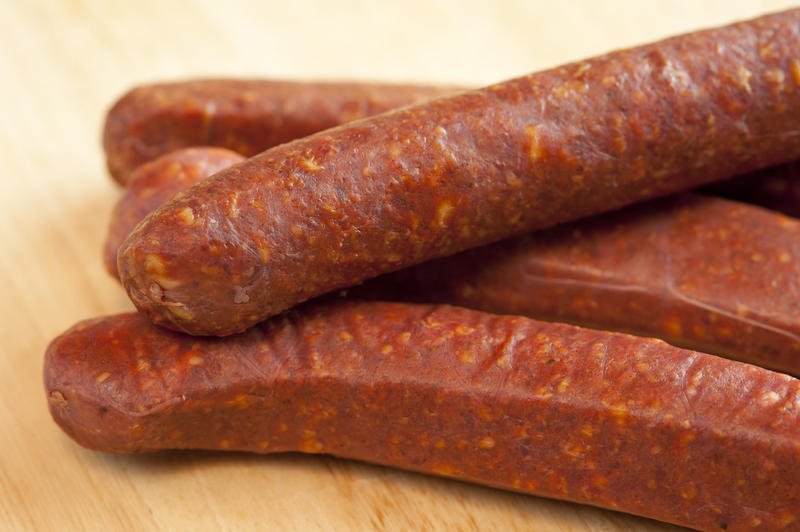 Close-up of four raw sausages. Macro