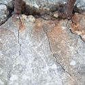 10930   Close Up of Rusted Rebar Mounted in Cracked Cement
