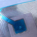 11115   Detail of Blue and Silver Radio Frequency ID Tag