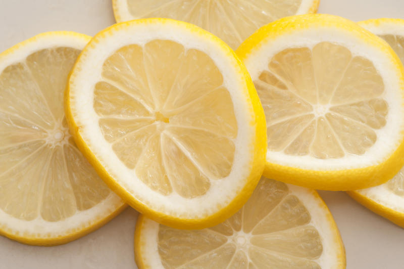 Sliced fresh lemon background with a stacked layer of ripe fresh juicy yellow lemon slices for use as a garnish