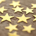 11202   Gold Stars Scattered on Wooden Surface