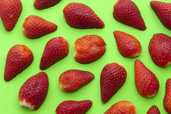 8522   Background of halved strawberries on green