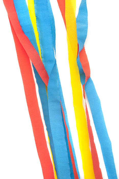 Close up Red, Blue and Yellow Party Streamers for Decoration Against White Background.