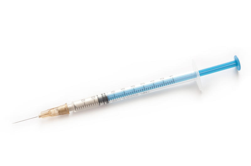Small disposable syringe and needle for subcutaneous or intramuscular application of liquid medication such as insulin in chronic diabetes, isolated on white