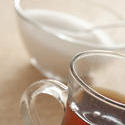 11661   Close up of glass of tea and bowl of sugar