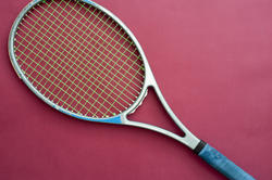 11007   Tennis Racket Isolated on Dark Pink Background
