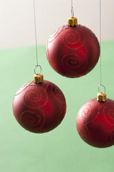 11694   Three hanging red Christmas baubles