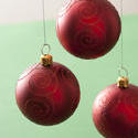 11694   Three hanging red Christmas baubles
