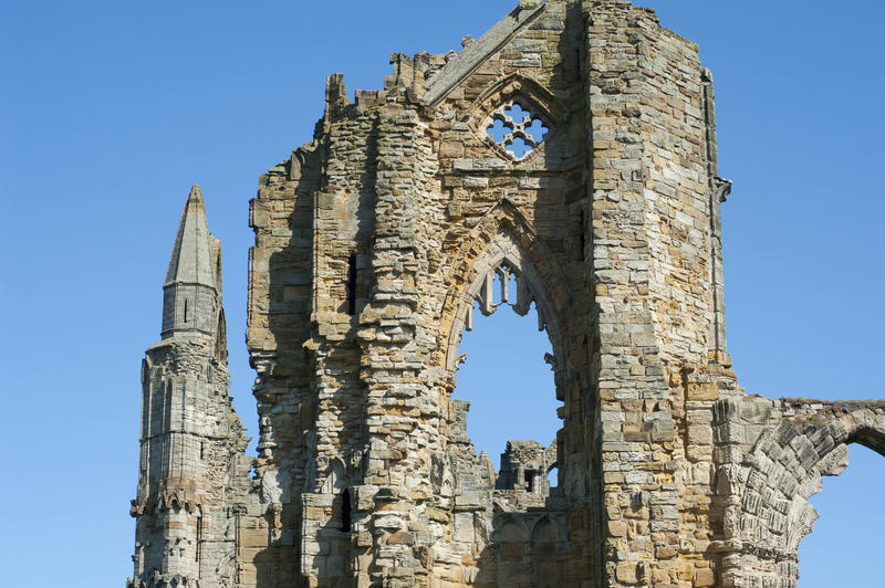 Closeup view of the stonework and arches of the Whitby Abbey ruins, a Benedictine monastery destroyed during the Dissolution of the Monastries under Henry VIII