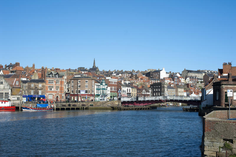 Whitby harbour and the swing bridge with the quay and waterfront builings with the town behind