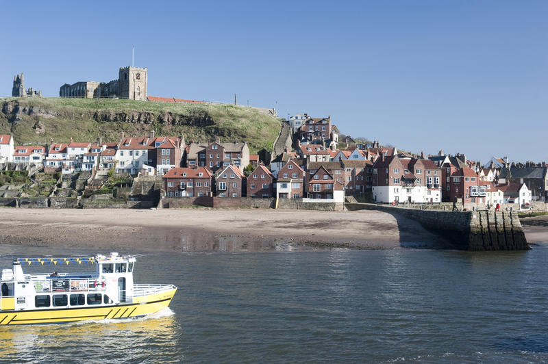 View across the harbour and River Esk to St Mary's Church in Whitby on top of Tate Hill on the Yorkshire coast