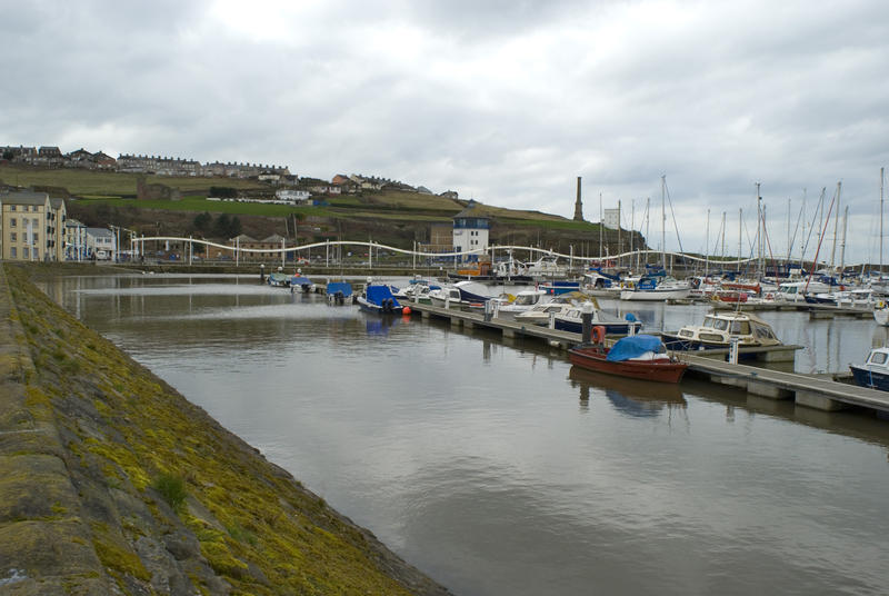 View of Whitehaven harbour with moored fishing boats and pleasure yachts in calm sheltered water