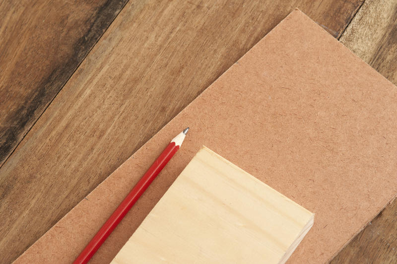 Woodworking background concept with a variety of different wood samples and a pencil for DIY home renovation and decorating