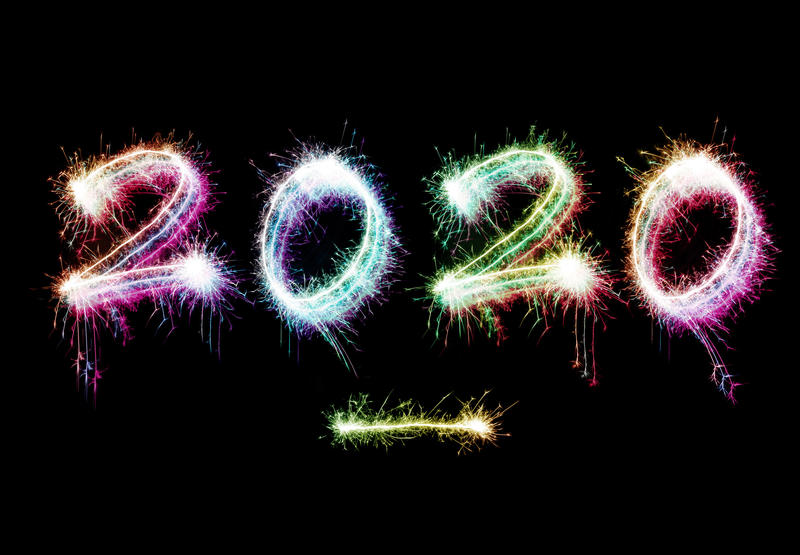 2020 New Year background with colorful sparklers forming a fiery date on a black background with copy space for a holiday greeting