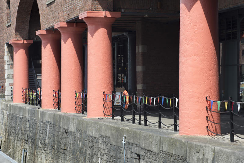 Line of red columns on the historic buildings at the Albert Dock, Liverpool, part of a UNESCO listed World Heritage Site