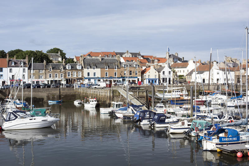 Pleasure and fishing boats moored in Anstruther harbour on the Fife coast of Scotland in a scenic waterfront view
