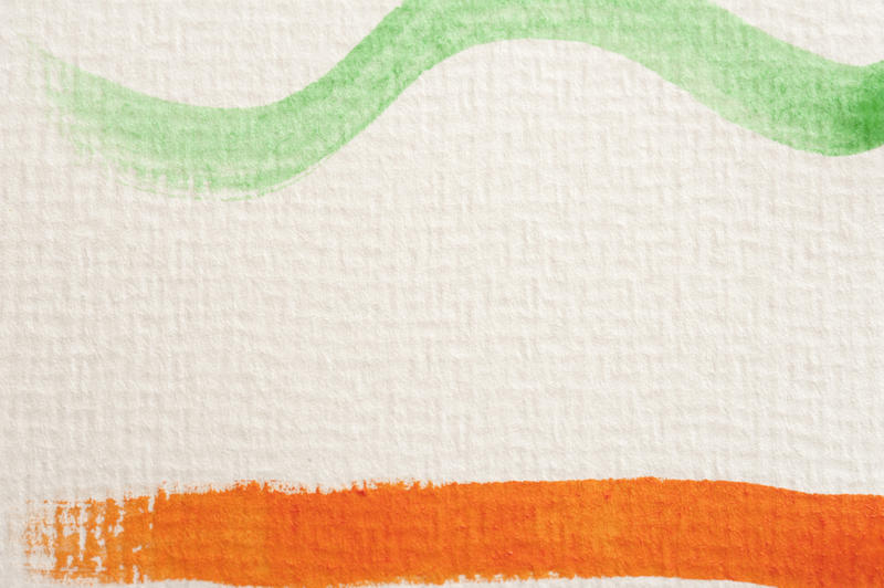 Close up view on curved green and straight orange paint strokes on canvas paper