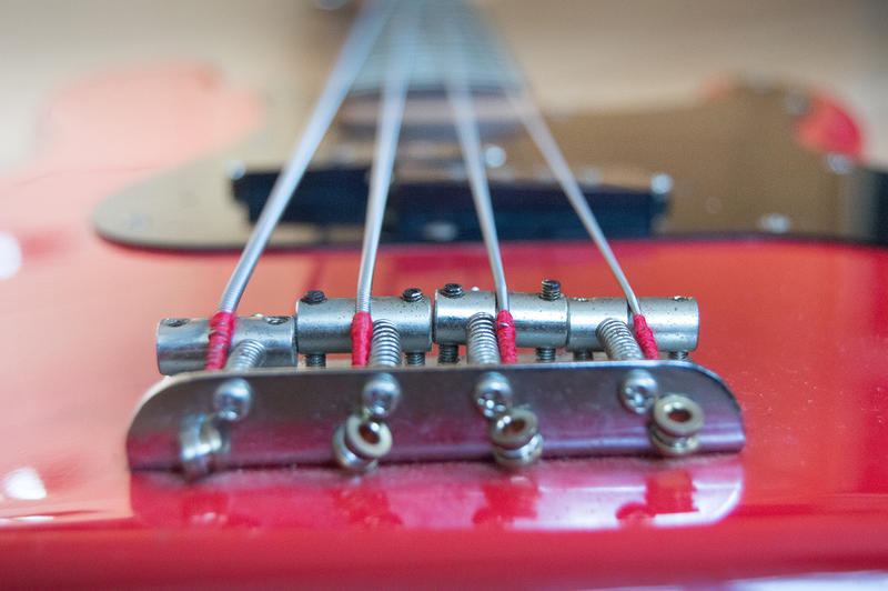 <p>A close-up phone of a red bass guitar</p>
Free bass guitar photo