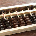 12724   Close up on abacus with brown and black counters