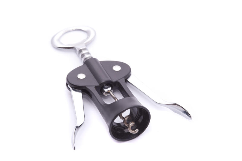 Plastic and metal corkscrew wine bottle opener with levers on white with copy space