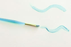 12147   Paintbrush with Blue Wavy Lines on White Paper