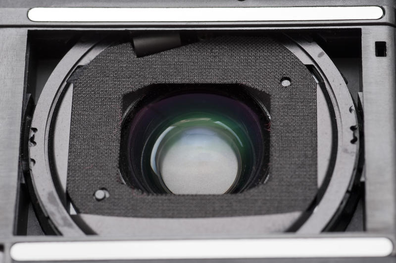 Extreme close up view on the inner section of a compact pocket camera lens