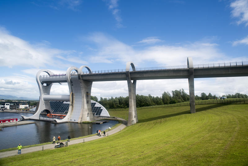 Sloping hill of well cut lawn under the famous Falkirk Wheel boat lift in Scotland