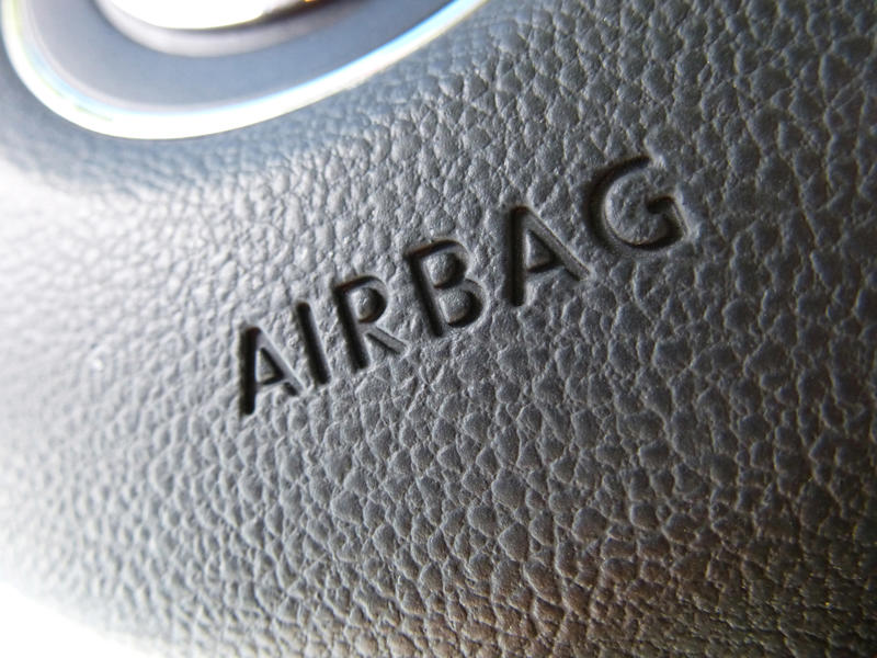 Extreme macro close up on airbag logo for steering wheel with rough textured surface