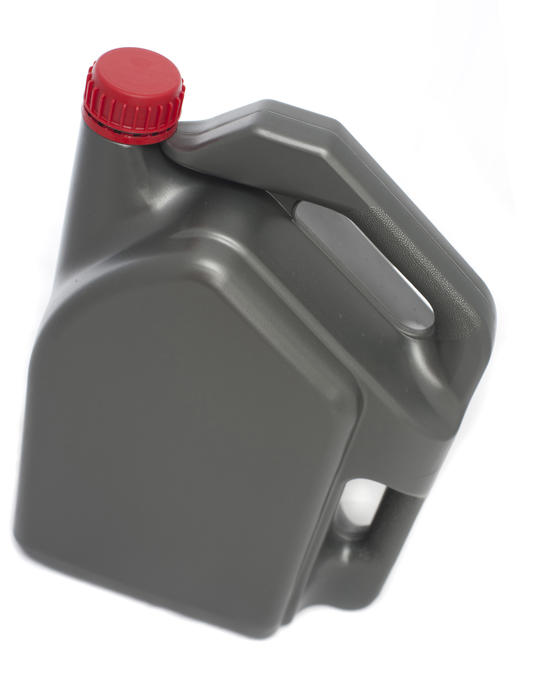 Isolated generic grey plastic bottle for automotive oil isolated on white with the label removed and a red cap - isolated on white