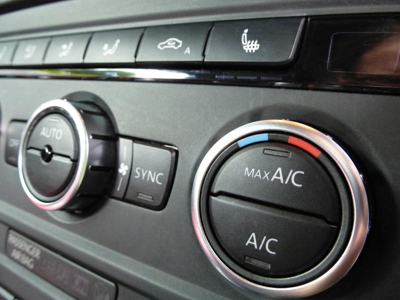 Wide angle close up view on environmental heating and air controls inside automobile