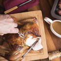 17168   Man carving the Christmas roast turkey for dinner
