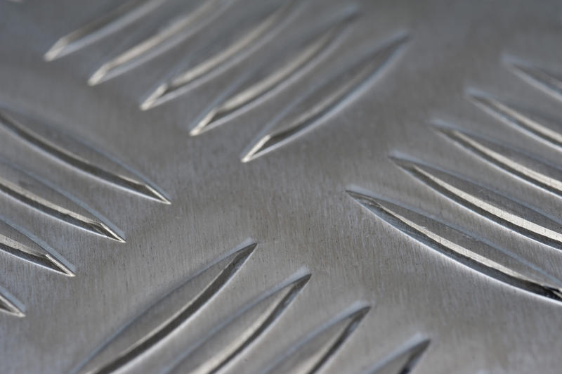 Unusual background with close up view of metal sheet with raised oval indentations