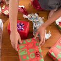 17214   Close up of teenager unwrapping Christmas presents