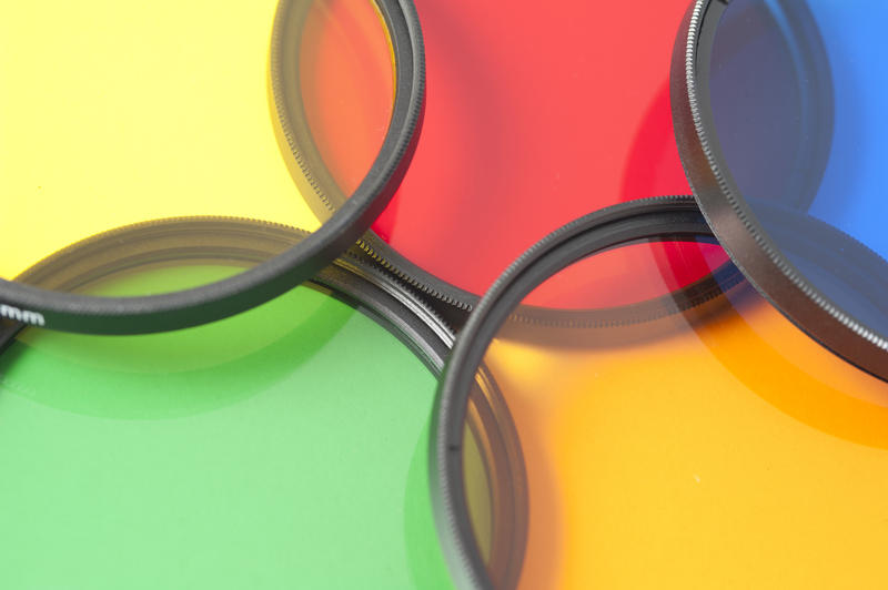 Extreme close up view on yellow, red, blue, green and orange contrast or polarizing filters for photography