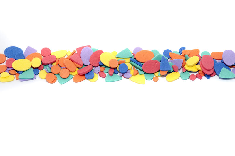 Colored shapes divider on white with a variety of different multicolored forms arranged in a row dividing the background into thirds with copy space